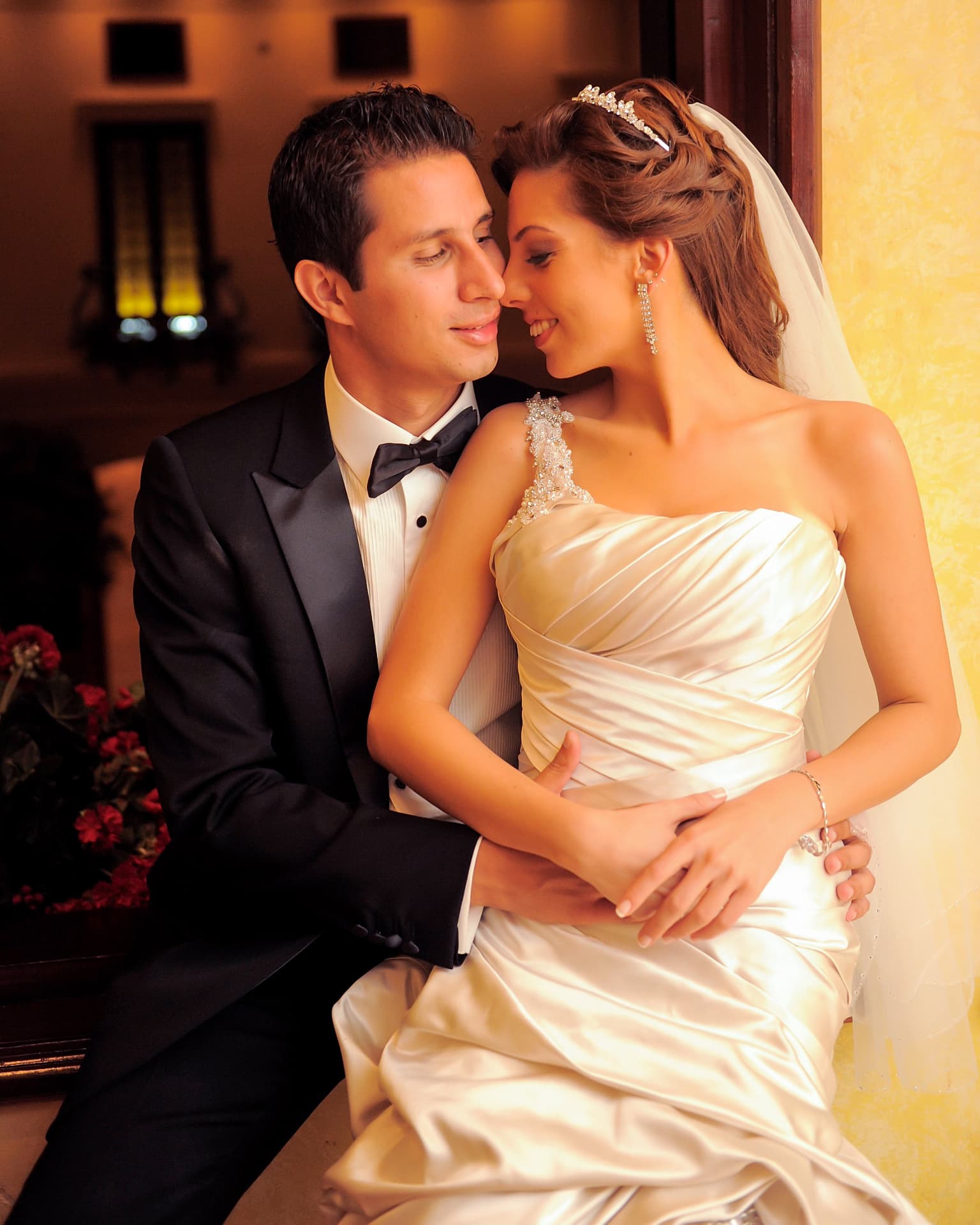 Couple seated together in warm candlelit interior
