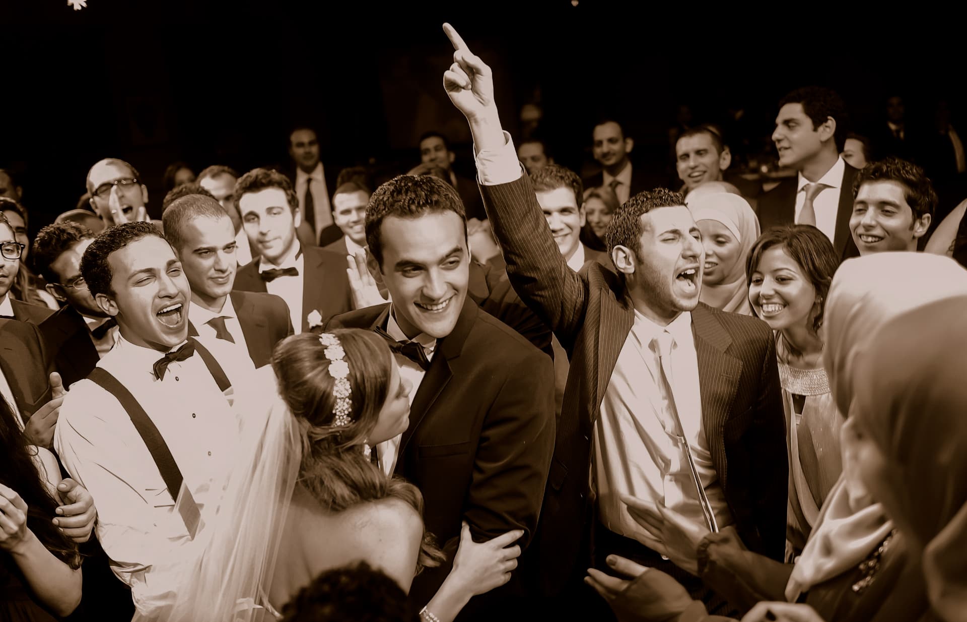 Groom celebrating with friends on the dance floor