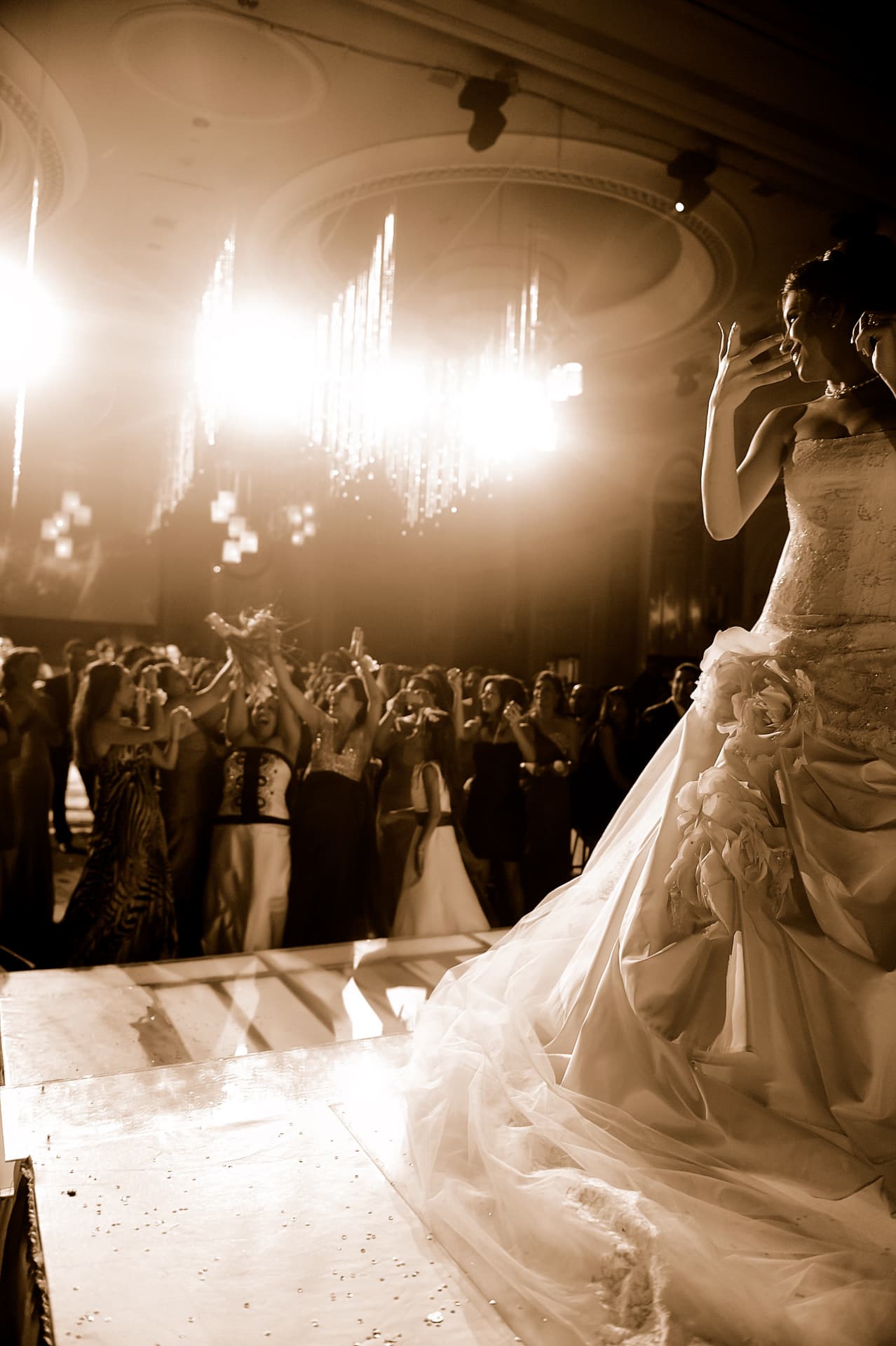 Bride blowing a kiss to the crowd from the stage