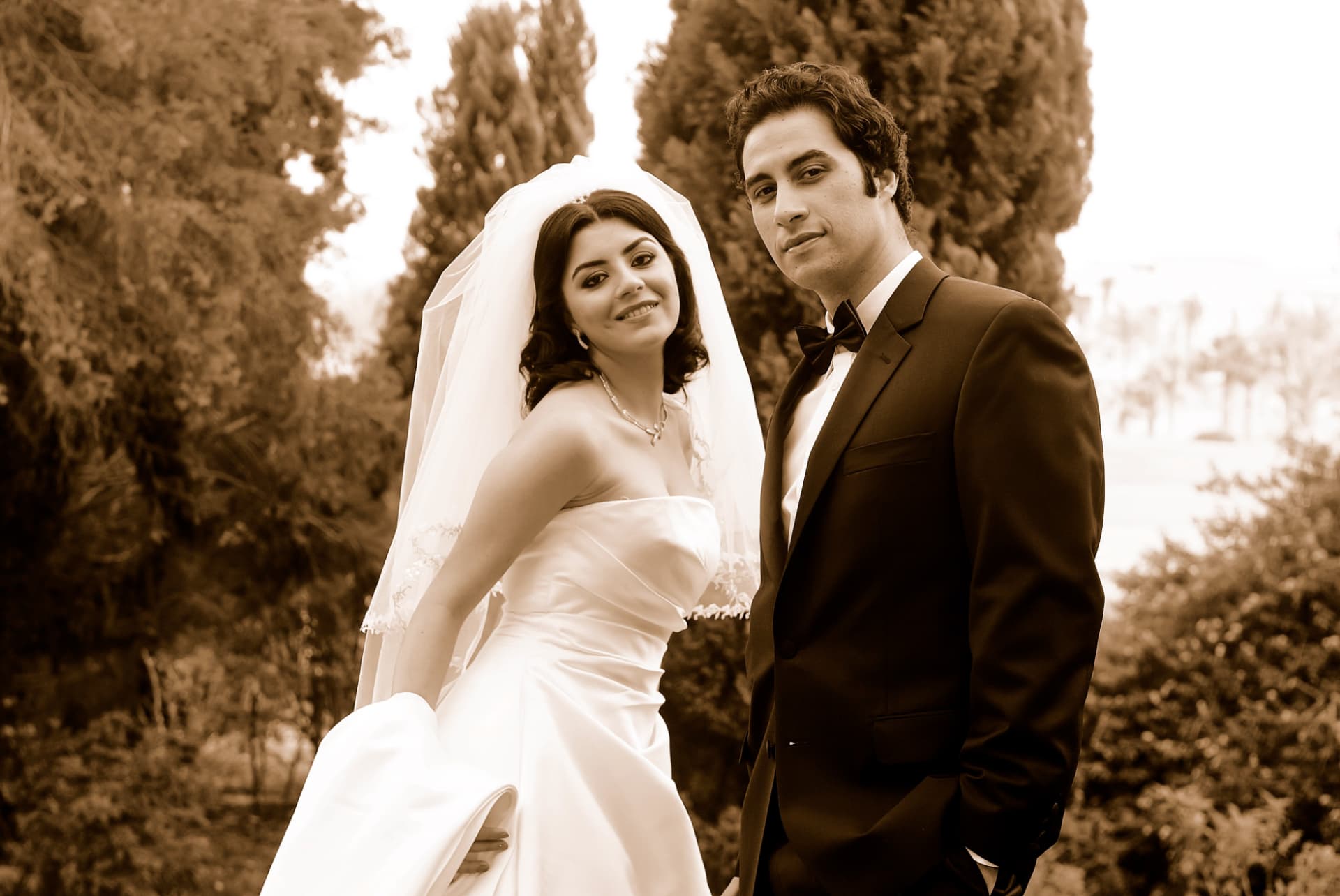 Sepia portrait of a bride and groom in a cypress garden