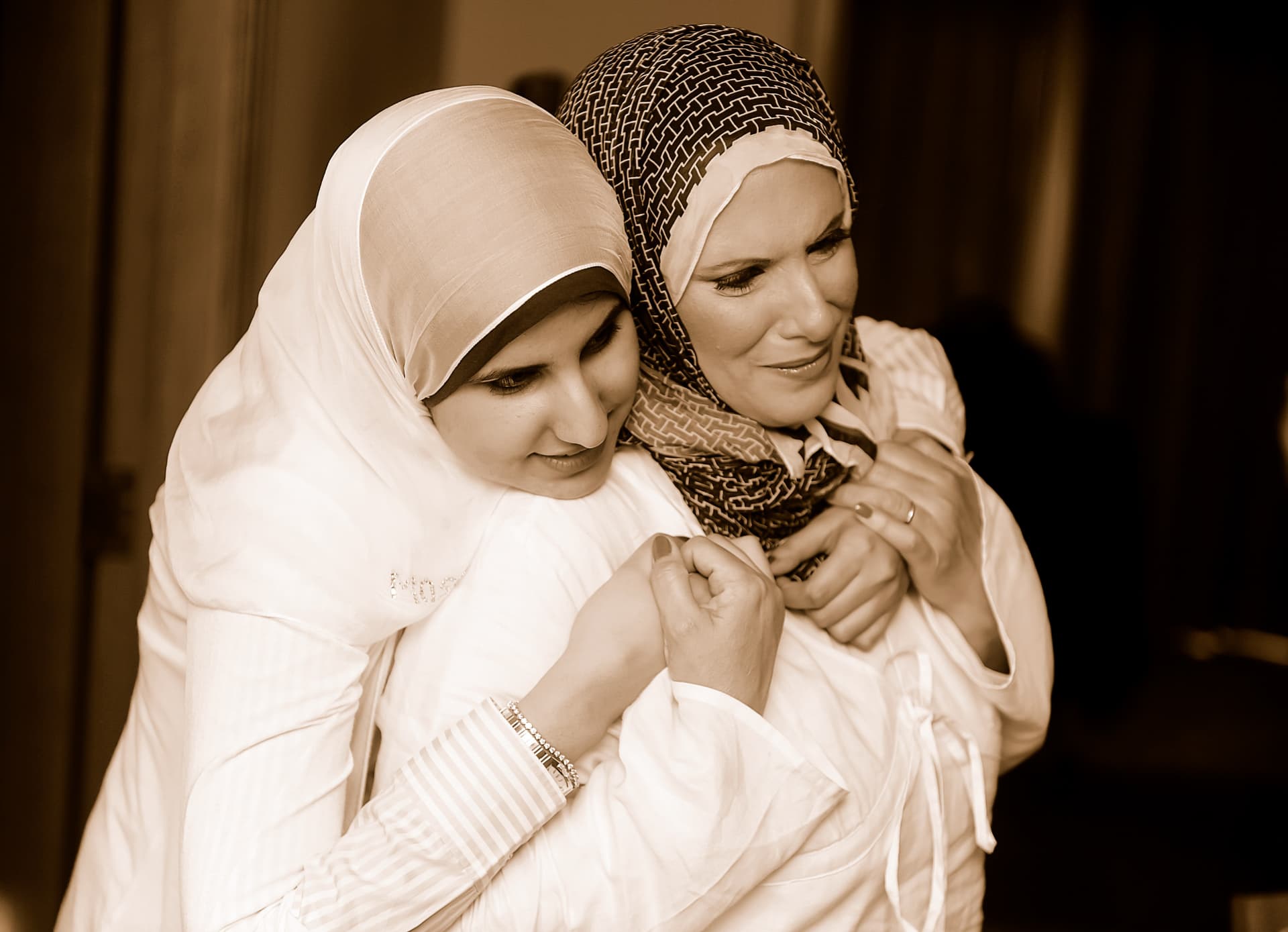 Bride embraced by her mother in a tender moment before the ceremony