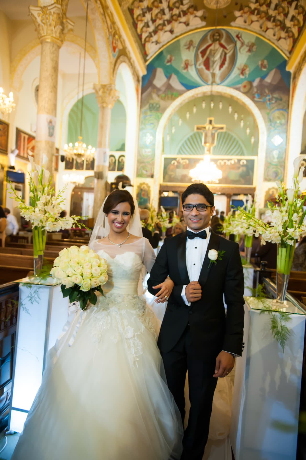 Bride and groom walking down the church aisle after the ceremony