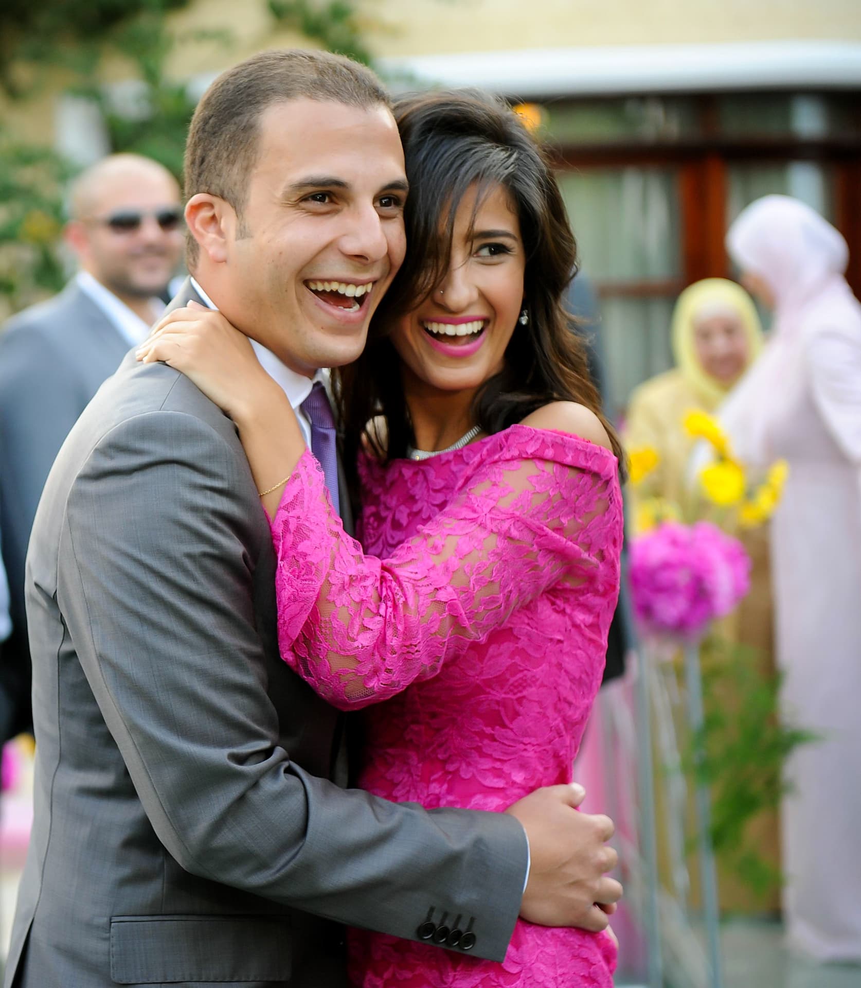 Guests laughing and embracing at a celebration