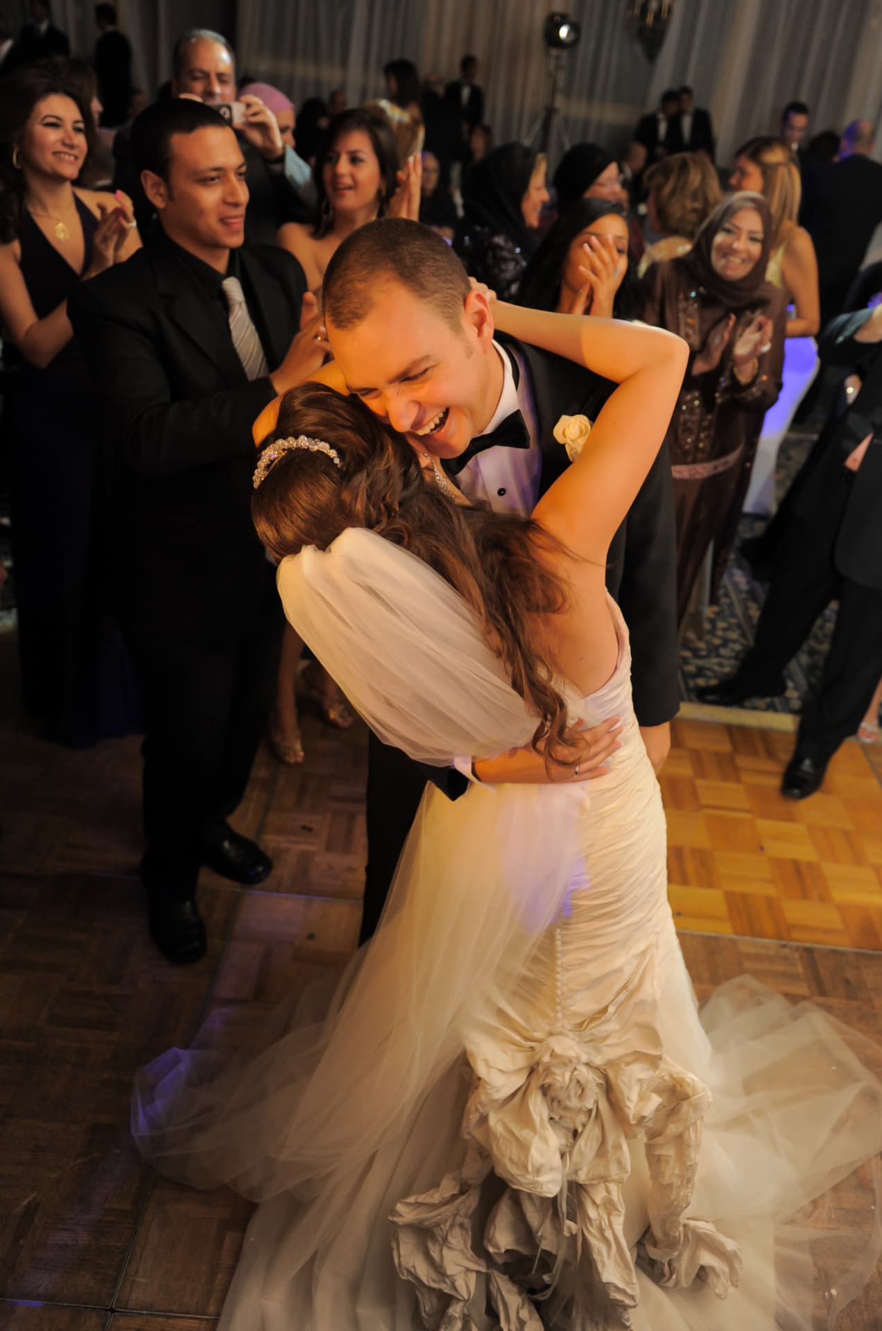 Bride and groom laughing during their first dance